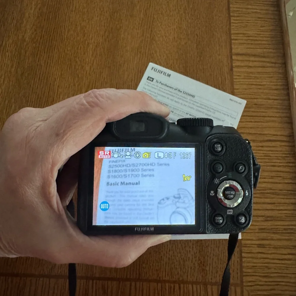 Fujifilm Black Digital Model S2550HD Camera with Zoom Lens and Ergonomic Grip.